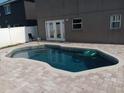 Inviting backyard pool featuring a paved patio area, perfect for relaxation and outdoor entertaining at 1321 Carey Glen Cir, Orlando, FL 32824