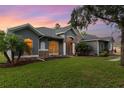 Charming exterior with stone accents, arched windows, and well-manicured lawn at 1333 Killbricken Cir, Ormond Beach, FL 32174