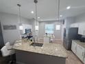Bright kitchen with granite counters, stainless appliances, and pendant lighting at 14400 Saint Georges Hill Dr, Orlando, FL 32828