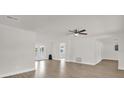 Bright living room with new laminate flooring and ceiling fan at 1491 Granada Ave, Daytona Beach, FL 32117