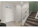 Inviting foyer with tile flooring, staircase, and ample natural light at 1553 Caterpillar St, St Cloud, FL 34771