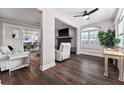 Bright living room with dark wood floors, fireplace, and an arched window with shutters at 1625 S Eola Dr, Orlando, FL 32806