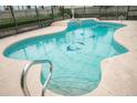 Inviting in-ground pool with clear blue water and decorative dolphin mosaics at 2 Pirates Cv, Ormond Beach, FL 32176