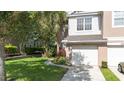 Inviting townhome with lush lawn, walkway, and a private one-car garage at 2110 Stockton Dr, Sanford, FL 32771