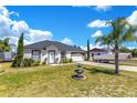 Beautiful single-story home with a well-manicured lawn, complemented by a boat in the driveway at 2397 Albury Ave, Deltona, FL 32738