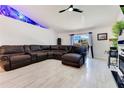 Comfortable living room with a large leather sectional and modern decor, creating a cozy atmosphere at 2397 Albury Ave, Deltona, FL 32738