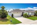 Well-maintained single-Gathering home featuring a spacious driveway and lush green lawn at 3216 Casa Del Rey Ave, Kissimmee, FL 34746