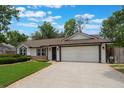 Charming one-story home with a well-manicured lawn and an attached two-car garage at 352 Inglenook Cir, Winter Springs, FL 32708