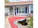 Inviting front porch with brick accents and decorative pond feature adds curb appeal at 4235 Shades Crest Ln, Sanford, FL 32773