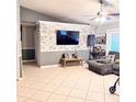 Open living room with tile flooring, neutral color palette, and stylish decorative accents at 4235 Shades Crest Ln, Sanford, FL 32773