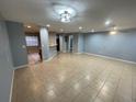 Open-concept living room and kitchen area featuring recessed lighting, neutral tile, and breakfast bar at 4503 Oak Arbor Cir, Orlando, FL 32808