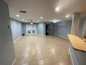 Spacious living room featuring neutral tile flooring, ceiling fan, and sliding glass doors at 4503 Oak Arbor Cir, Orlando, FL 32808