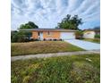Charming single-story home featuring a light orange exterior and a spacious two-car garage at 4840 Judy Ann Ct, Orlando, FL 32808