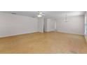 Large living area with hardwood floors and neutral walls, offering ample space for furniture at 520 Farmingham Ct, Oviedo, FL 32765