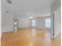 Spacious living room with hardwood floors, bright windows, and a modern ceiling fan at 520 Farmingham Ct, Oviedo, FL 32765