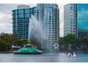 Scenic view of Lake Eola with fountain, surrounding buildings, and swan paddle boat at 641 E Livingston St, Orlando, FL 32803
