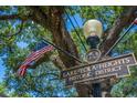 Historic Lake Eola Heights district sign surrounded by a large tree and American flag at 641 E Livingston St, Orlando, FL 32803
