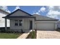 Charming single Gathering home with a two car garage and nicely manicured lawn at 707 Junonia Blvd, New Smyrna Beach, FL 32168