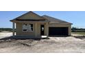 Charming one-story home featuring a covered porch and a two-car garage at 707 Junonia Blvd, New Smyrna Beach, FL 32168