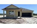 Charming one-story home featuring a covered porch and a two-car garage at 707 Junonia Blvd, New Smyrna Beach, FL 32168
