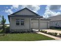 Charming single Gathering home with a two car garage and nicely manicured lawn at 707 Junonia Blvd, New Smyrna Beach, FL 32168