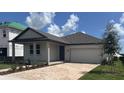 Charming single Gathering home with a two car garage and nicely manicured lawn at 707 Junonia Blvd, New Smyrna Beach, FL 32168