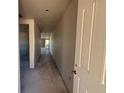 Long hallway leading into the house, with unfinished walls and concrete floors at 707 Junonia Blvd, New Smyrna Beach, FL 32168