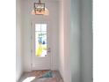 Bright and inviting front foyer with tiled floors, a front door with glass window, and views of the front yard at 726 Coral Reef Way, Daytona Beach, FL 32124
