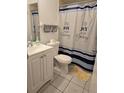 Cozy bathroom with shower curtain, tile flooring, and functional fixtures at 837 Pebble Creek Cir, Orlando, FL 32824