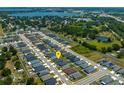 An aerial view showing the home's neighborhood with ponds and greenery in the distance at 871 Orleans Dr, Eagle Lake, FL 33839