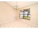 Bright dining room with tile flooring and a large window overlooking the yard at 984 Dinero Dr, Winter Springs, FL 32708
