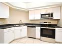 Bright kitchen featuring stainless steel appliances and sleek, white cabinetry at 984 Dinero Dr, Winter Springs, FL 32708