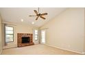 Inviting living room with a brick fireplace, neutral walls, and ample natural light at 984 Dinero Dr, Winter Springs, FL 32708