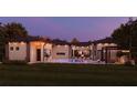 Beautiful backyard showcasing a sparkling pool, lounge chairs, a pergola, and a fire pit area at 12818 Brunello Cir, Clermont, FL 34711
