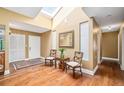 Bright foyer with skylight, hardwood floors, and decorative mirror, creating a welcoming entrance at 134 Heron Bay Cir, Lake Mary, FL 32746