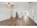 Open-concept living space with vaulted ceilings, and wood-look flooring at 13881 Sw 80Th Ave, Ocala, FL 34473
