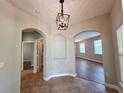 Inviting foyer with tiled floor, decorative lighting, and arched doorways at 14479 Tanja King Blvd, Orlando, FL 32828