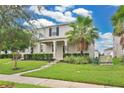 Charming home with lush landscaping, healthy lawn, and a welcoming walkway to the front door at 15060 Book Club Rd, Winter Garden, FL 34787