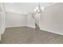 Open-concept living room with laminate flooring and a chandelier at 15060 Book Club Rd, Winter Garden, FL 34787