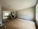 An open-concept living room with tile flooring and abundant natural light. Ready for personalization at 15345 Burgtheater Dr, Winter Garden, FL 34787