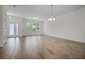 Bright, spacious living room with tile floors and large windows providing natural light at 15477 Blackbead St, Winter Garden, FL 34787