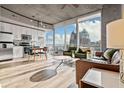 Bright, open living space with modern kitchen, large windows, and city views at 155 S Court Ave # 2406, Orlando, FL 32801