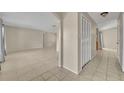 Spacious living room with tile floors and neutral walls with easy access to other rooms at 15628 Hidden Lake Cir, Clermont, FL 34711