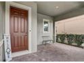Cozy front porch with brick flooring and a sitting area, perfect for relaxing at 17084 Harbor Oak Pkwy, Winter Garden, FL 34787