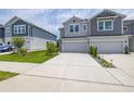 Wide concrete driveway leading to attached garages, with green lawns on either side at 1915 Terrapin Rd, Ocoee, FL 34761