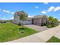 Attractive curb appeal with manicured lawn, paved driveway, and a charming two-story home at 2388 Volunteer Ave, Kissimmee, FL 34744