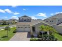 Stunning two-story home featuring a two-car garage, beautiful landscaping, and a welcoming porch at 2388 Volunteer Ave, Kissimmee, FL 34744
