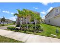 Eye-catching home with stone accents, complemented by lush landscaping and vibrant palm trees at 2388 Volunteer Ave, Kissimmee, FL 34744