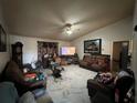 Spacious living room featuring tiled floors, a ceiling fan, and ample seating at 2558 El Capitan Dr, Sanford, FL 32773