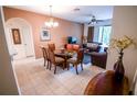 Open dining area flowing into the living room, featuring a glass-top table and neutral decor at 2788 Almaton Loop # 202, Kissimmee, FL 34747